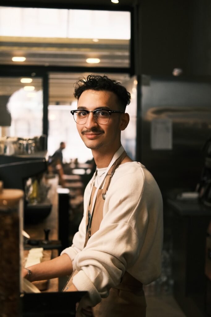A man standing in front of a counter in a restaurant