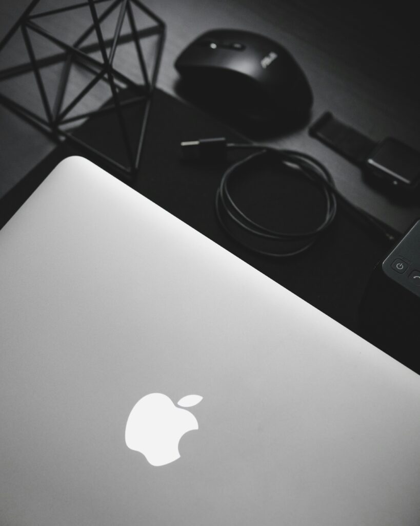 MacBook near black computer mouse MacBook near black computer mouse